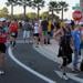 Triathletes running around corner, supporters watching