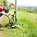 Triathlete repairing bike tire on roadside