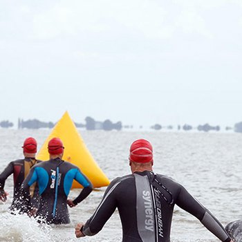 Triathletes entering water 5150 Westfriesland