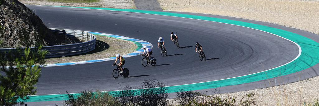 5 Athletes cycling on the Formula 1 track as part of the IRONMAN Portugal 