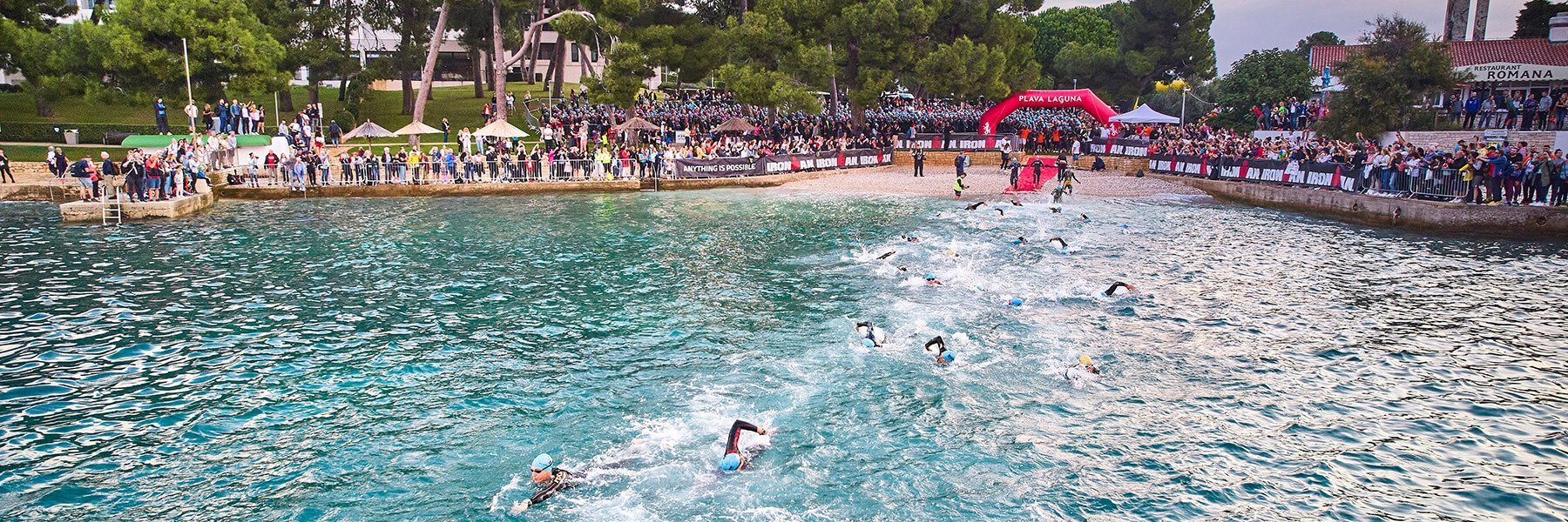 Plava Laguna IRONMAN 70.3 Porec Croatia athletes swimming to the finish line