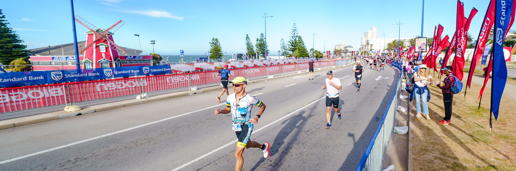 Athletes running along the Summerstrand and Humewood beach fronts while enjoying the support of spectators at IRONMAN African Championship
