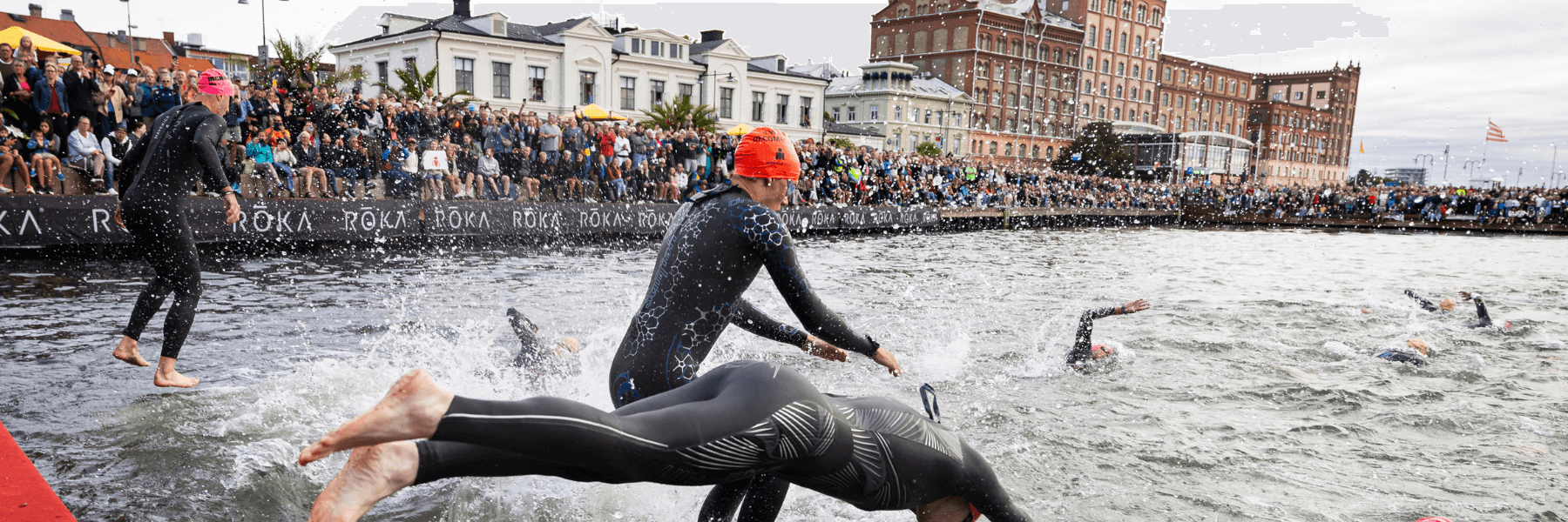 Athletes at the swim start of IRONMAN Kalmar getting into the water