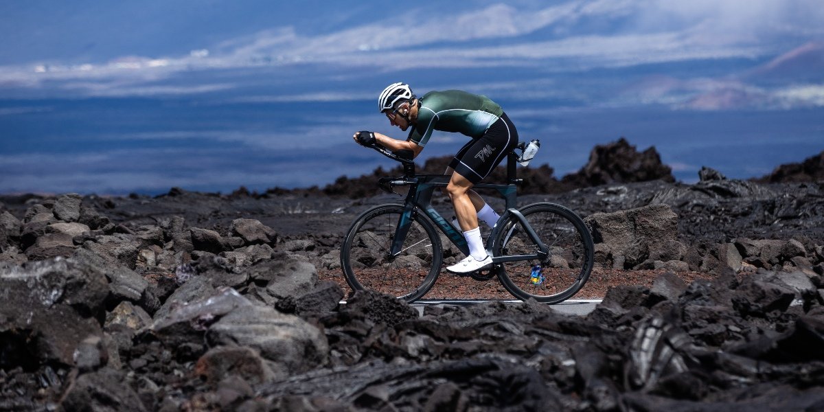 Matt Burton riding through the lava fields of Kona ahead of the 2022 VinFast IRONMAN World Championship