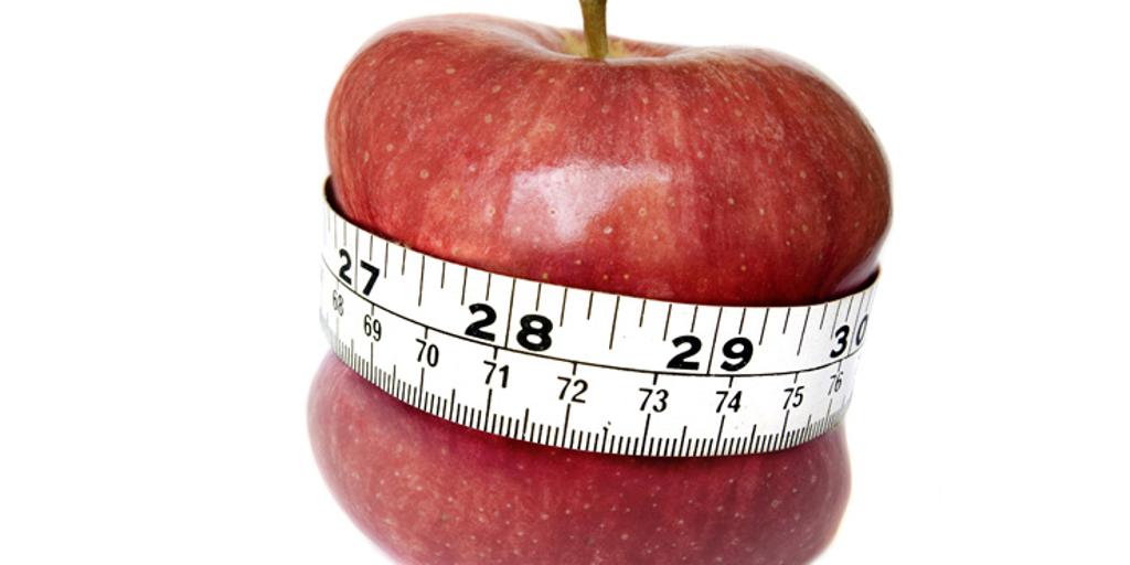 Red apple with tape measure around middle