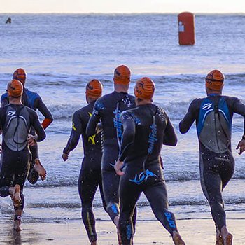 Triathletes running to enter water IM Mar del Plata