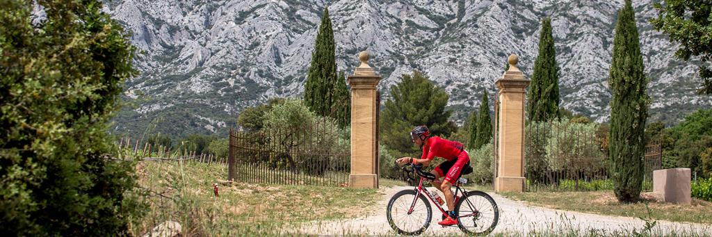 IRONMAN 70.3 ays d'Aix-en-Provence athlete biking through beautiful landscape of Provence