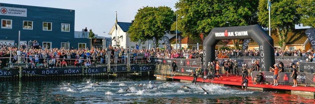 Athletes at the swim start of IRONMAN Kalmar getting into the water
