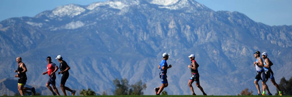Triathletes running, mountains in background, IRONMAN Indian Wells 70.3
