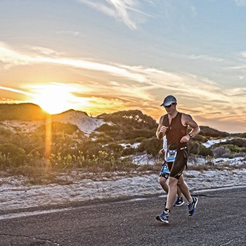 Triathlete running at sunset IM703 Gulf Coast