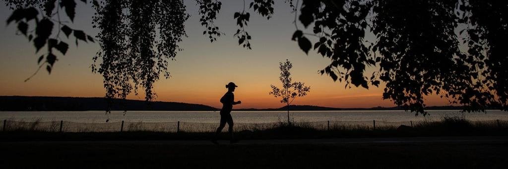 One Athlete Running while sunset at IRONMAN 70.3 Finland in Lahti