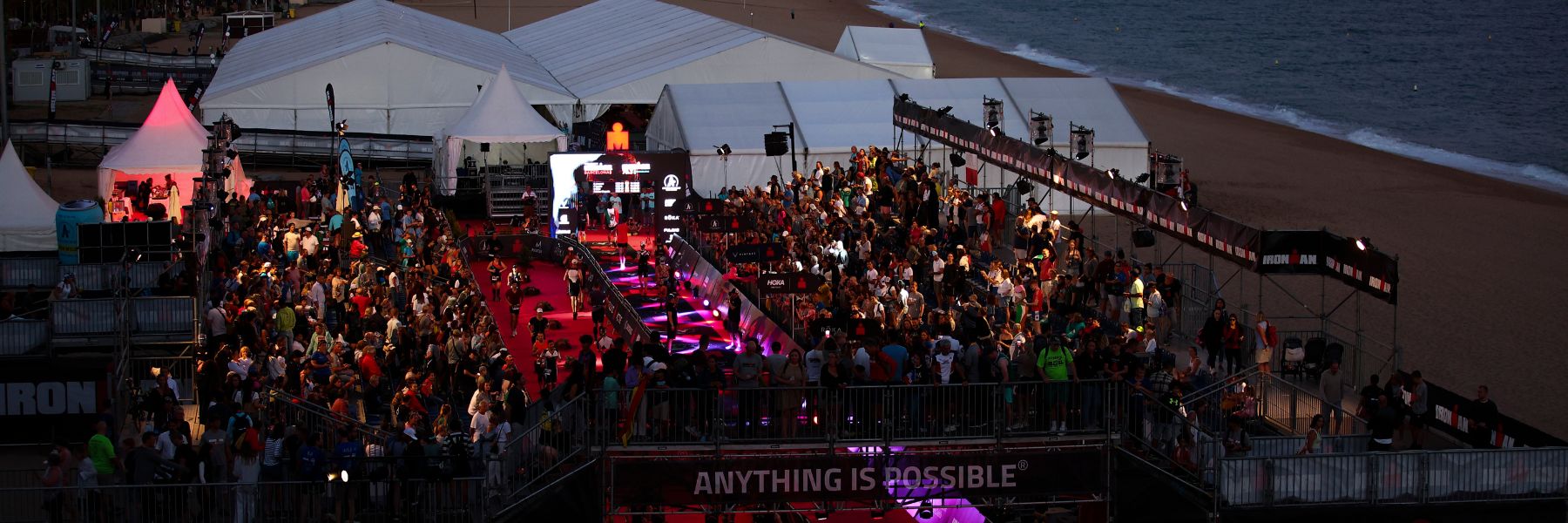 Bird's eye view of the IRONMAN Barcelona magic finish line at the beach of Calella at night