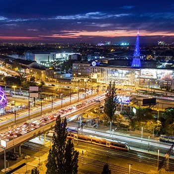 Bird's eye view of Poznan city at night with city lights lightning up 