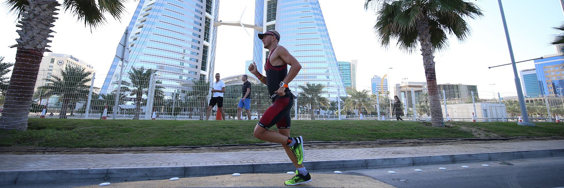 Single athlete passing by Bahrain World Trade Center while running along King Faisal Highway at IRONMAN 70.3 Bahrain