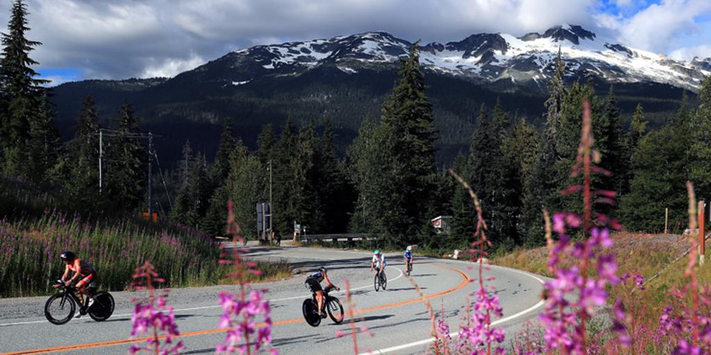 Triathletes biking near mountains in Canada
