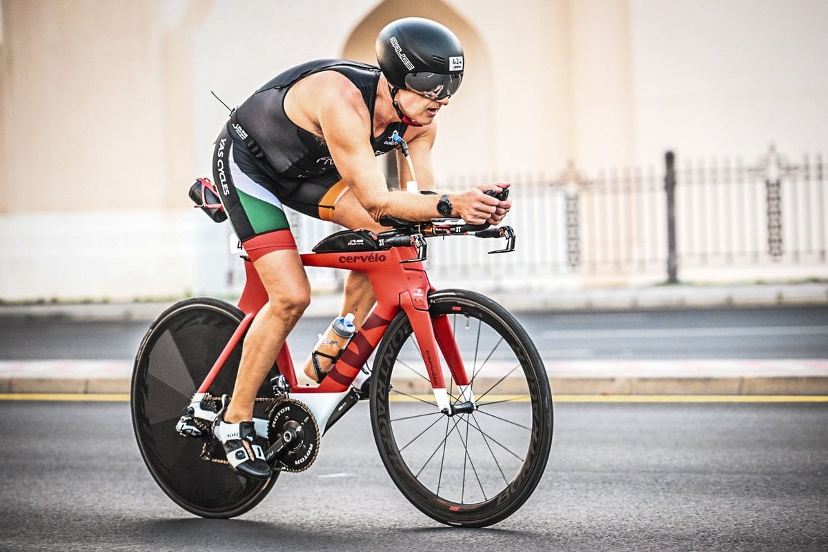 IRONMAn 70.3 Oman athletes riding a bike