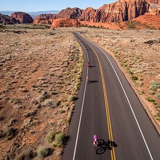 Triathletes biking in a desert climate