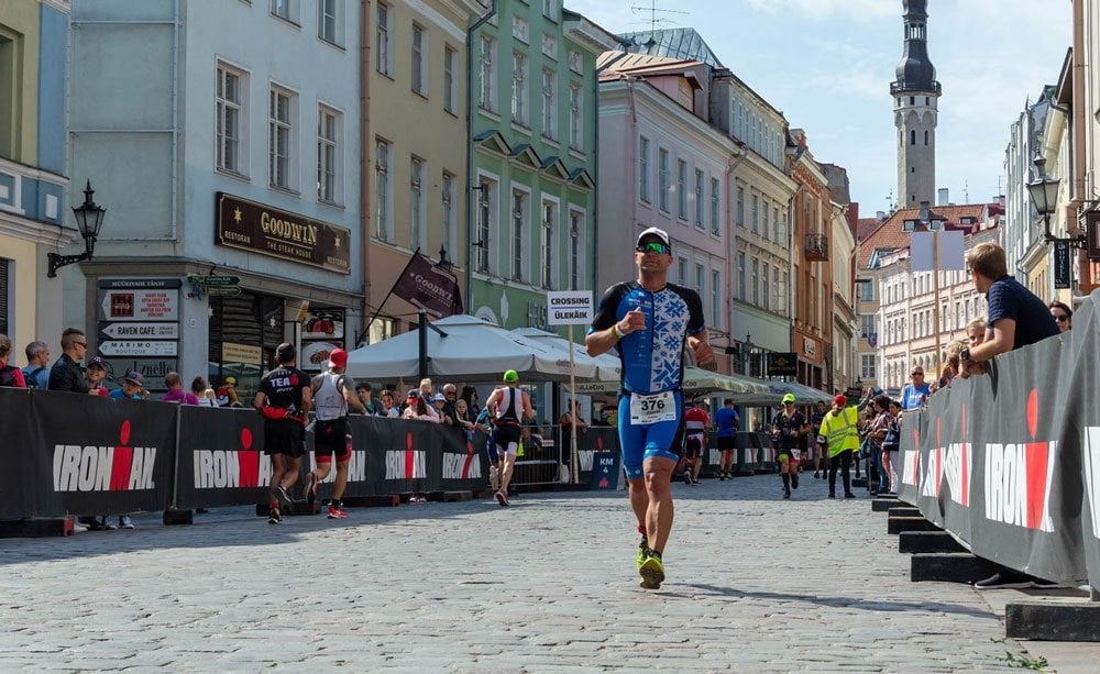 Athlete running through the old town at IRONMAN Tallinn